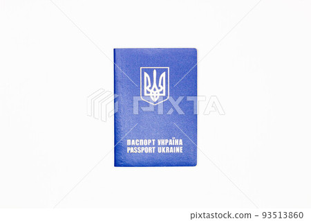 Passport of Ukraine. The cover of the State document of the foreign Ukrainian Passport with the coat of arms of Ukraine in blue on a white background. Top view. Close-up 93513860