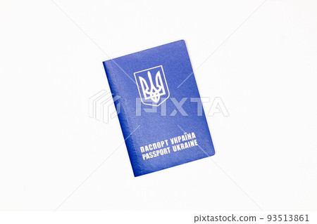 Passport of Ukraine. The cover of the State document of the foreign Ukrainian Passport with the coat of arms of Ukraine in blue on a white background. Image at an angle. Top view. Close-up Passport of Ukraine. The cover of the State document of the foreign Ukrainian Passport with the coat of arms of Ukraine in blue on a white background. Image at an angle. Top view. Close-up 93513861
