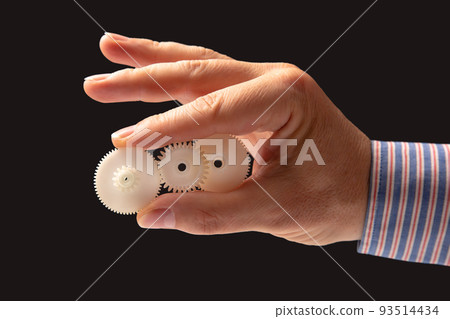 white plastic gears in hand. machine motion transmission mechanism white plastic gears in hand. machine motion transmission mechanism 93514434