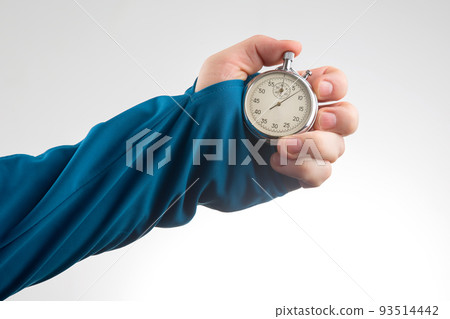 hand with a mechanical stopwatch on a white background. Time part precision. 93514442