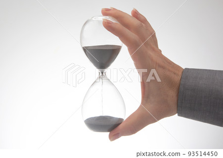 Hourglass on a light background. Time is money. Business solutions in time. 93514450
