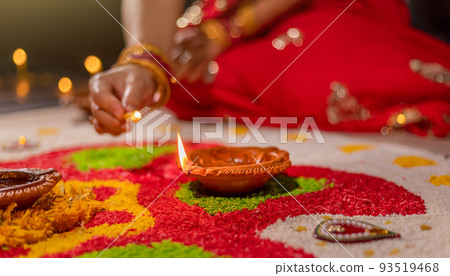 Traditional diya lamps lit during diwali celebration Traditional diya lamps lit during diwali celebration 93519468