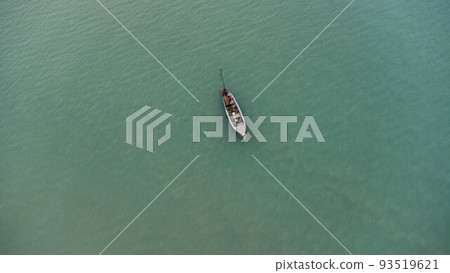 Aerial view from a drone of Thai traditional longtail fishing boats sailing in the sea. Top view of a fishing boat in the ocean. 93519621