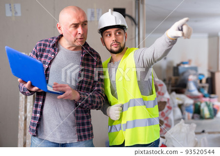 Designer and foreman talking about work in construction site Designer and foreman talking about work in construction site 93520544