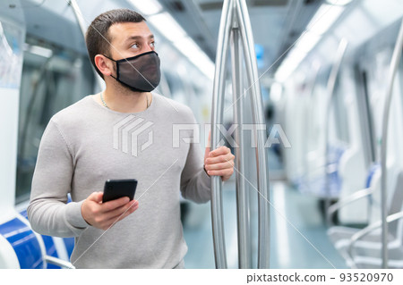 Man in protective medical masks in subway carriage Man in protective medical masks in subway carriage 93520970