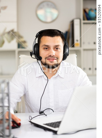 Portrait of positive man office worker wearing headset 93520994