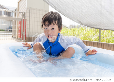 Boy playing in a plastic pool Boy playing in a plastic pool 93522006