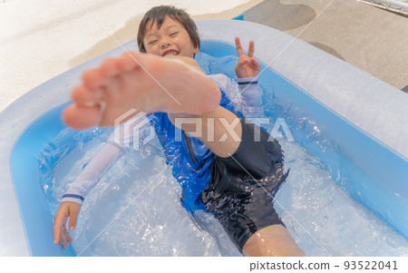 Boy playing in a plastic pool 93522041