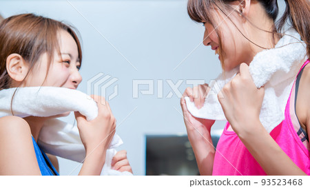 Young woman preparing in gym gym locker 93523468