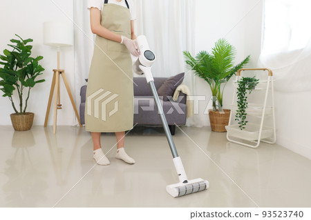 Lifestyle in living room concept, Young Asian woman using vacuum cleaner to cleaning the floor Lifestyle in living room concept, Young Asian woman using vacuum cleaner to cleaning the floor 93523740