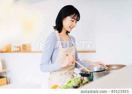 Woman cooking in the kitchen Woman cooking in the kitchen 93523955