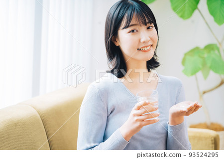 Woman taking medicine Woman taking medicine 93524295