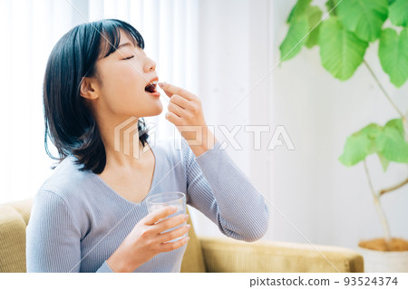 Woman taking medicine 93524374