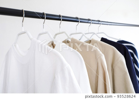 Clothes lined up on a hanger rack Simple image 93528624