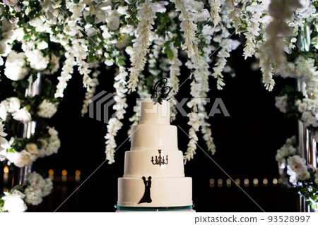 Multilevel wedding cake decorated with colorful flower Multilevel wedding cake decorated with colorful flower 93528997