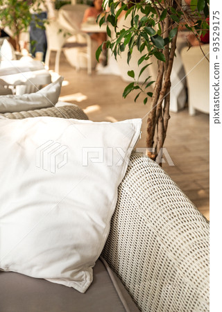 Rattan couch with cushion in boho style patio Rattan couch with cushion in boho style patio 93529175