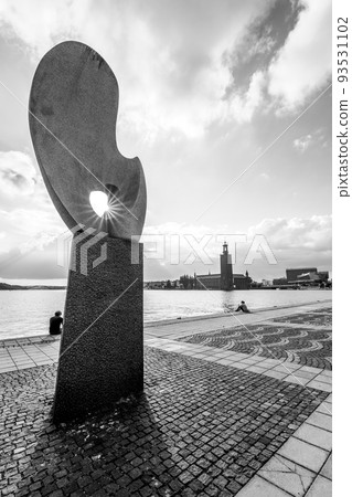 People relaxing on embankment in Stockholm 93531102