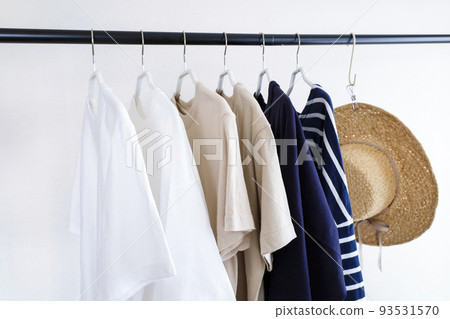 Clothes and hats lined up on a hanger rack Clothes and hats lined up on a hanger rack 93531570
