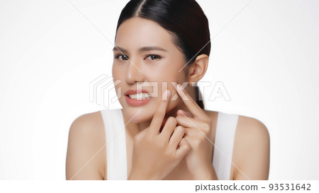 Unhappy young Asian woman squeezing her pimple, removing pimple from her face. Woman skin care concept. Unhappy young Asian woman squeezing her pimple, removing pimple from her face. Woman skin care concept. 93531642