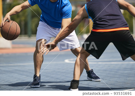 young asian men playing basketball 93531691