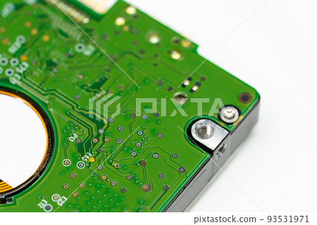 Closed up shot of an internal Hard disk electronic board in green color. 93531971