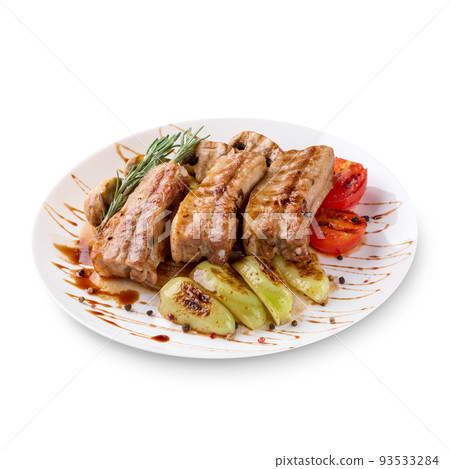 Tasty grilled ribs with vegetables on plate, isolated on white background Tasty grilled ribs with vegetables on plate, isolated on white background 93533284