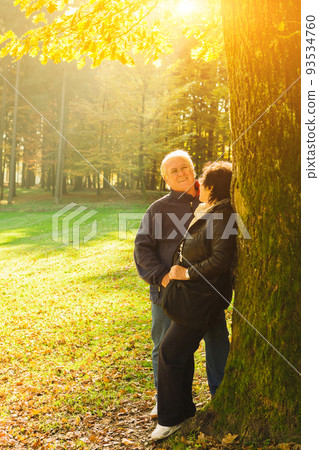 Senior couple enjoying time at the park at the sunset. Concerpt Family 93534760