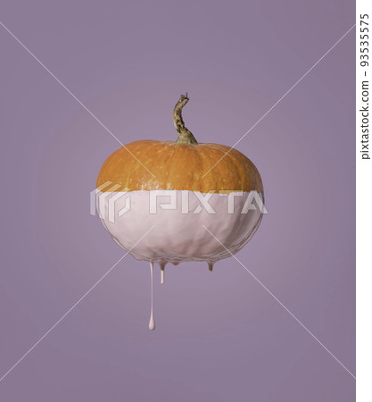 Decoration for Halloween. An orange pumpkin with paint running down it. minimalistic concept with purple background Decoration for Halloween. An orange pumpkin with paint running down it. minimalistic concept with purple background 93535575