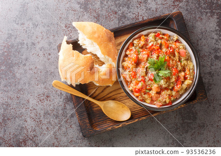 vegetable stew of eggplant, tomatoes, bell peppers, garlic seasoned with olive oil close-up in a bowl. Horizontal top view 93536236