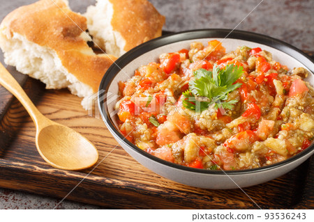 Kyopolou is a delicious and refreshing Bulgarian and Turkish spread made from roasted peppers and eggplants closeup in the bowl. Horizontal 93536243