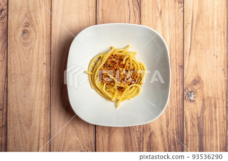 Bucatini spaghetti pasta aglio e olio with chili flakes parsley garlic . Concept classic Italian cousine Bucatini spaghetti pasta aglio e olio with chili flakes parsley garlic . Concept classic Italian cousine 93536290