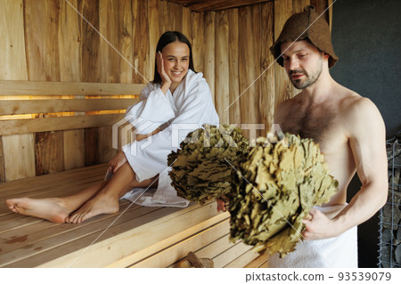 Cheerful couple relaxing in sauna during spa treatments 93539079