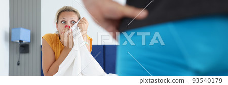 Amazed woman looks at man in bedroom 93540179