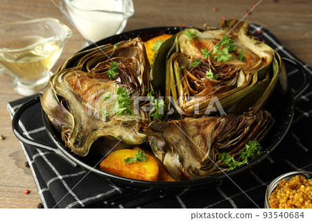 Concept of tasty food with grilled artichoke, close up Concept of tasty food with grilled artichoke, close up 93540684