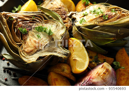 Concept of tasty food with grilled artichoke, close up Concept of tasty food with grilled artichoke, close up 93540693