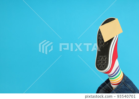 Blank sticker pasted on red sneaker on blue background Blank sticker pasted on red sneaker on blue background 93540701