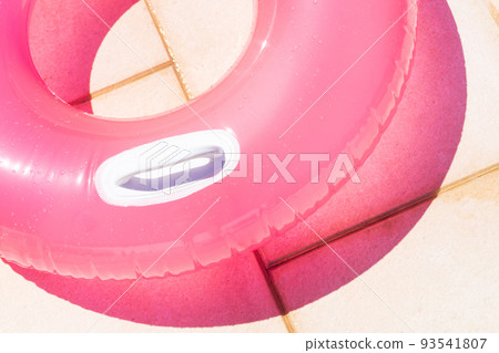 Translucent pink swim ring under the bright sun Translucent pink swim ring under the bright sun 93541807