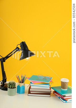 Concept of preparing to exams or tests on yellow background 93542504