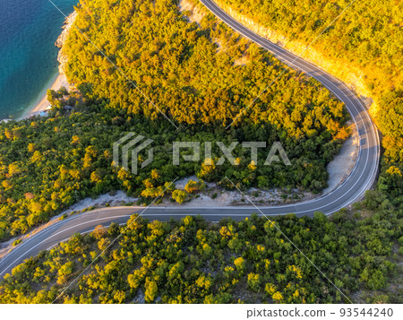 Winding coastal road at sunrise 93544240