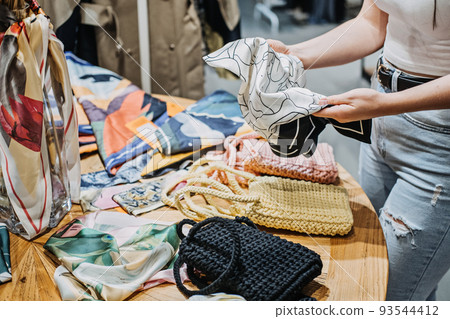 Sustainable fashion. Modern Latina young woman choosing vintage scarf, 93544412