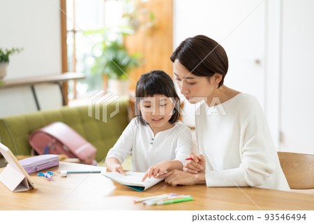 Elementary school girl and mom studying in the living room 93546494