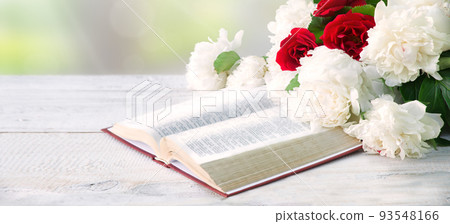 Bible and a bouquet of peonies on a table Bible and a bouquet of peonies on a table 93548166