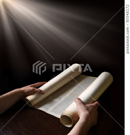 Hands holding an ancient scroll Hands holding an ancient scroll 93548172