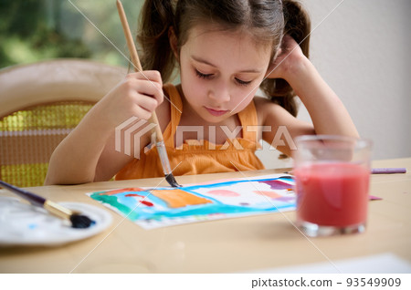 Concentrated Caucasian smart little preschooler girl, painting picture with watercolors and paintbrush. Drawing. Art class. Painting Concentrated Caucasian smart little preschooler girl, painting picture with watercolors and paintbrush. Drawing. Art class. Painting 93549909