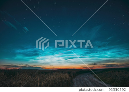 Amazing Rotate Stars Effect In Sky. Soft Colors. 6k Unusual Cloud And Stars Effects Above Countryside Rural Field Landscape With Young Wheat Sprouts. Night Blue Sky. , 93550592