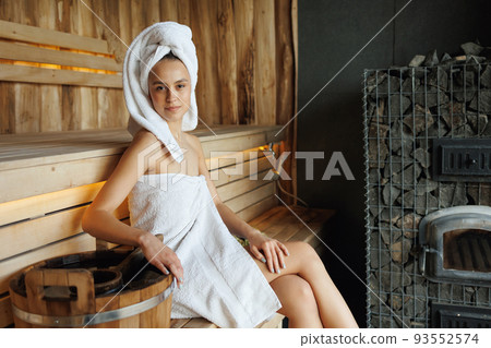 Pretty woman in wooden sauna 93552574