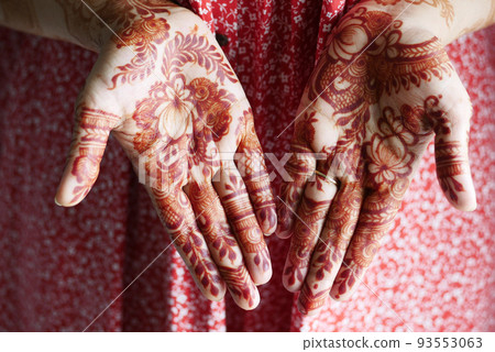 women applying henna on hand women applying henna on hand 93553063