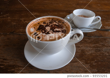 A cup of coffee topped with cinnamon A cup of coffee topped with cinnamon 93553201
