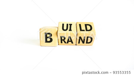 Build your brand symbol. Concept words Build brand on wooden cubes. Beautiful white table white background. Build your brand and business concept. Copy space. 93553355