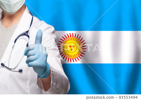 Argentine doctor's hand showing thumb up positive gesture on flag of Argentina background Argentine doctor's hand showing thumb up positive gesture on flag of Argentina background 93553494